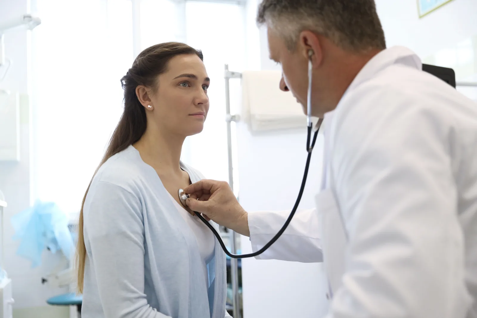 A doctor listening to a patient’s heart at Allied Family Health